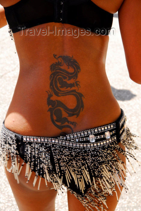 girl with dragon tattoo back. Tobago: tattoo of a dragon