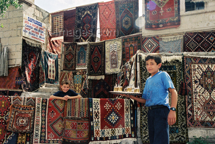turkey120: Turkey - Derinkuyu: erving tea in front of carpets - quintessential Turkish scene - photo by J.Kaman - (c) Travel-Images.com - Stock Photography agency - Image Bank