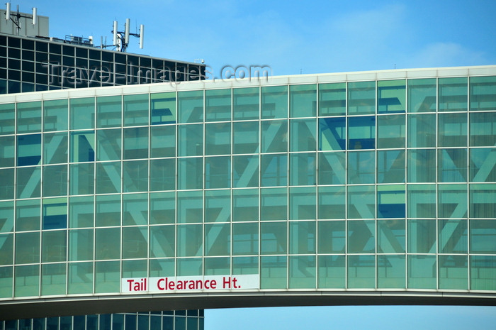 usa1443: Denver, Colorado, USA: Denver International Airport - pedestrian bridge between the Jeppesen terminal and Concourse A - steel truss structure encased in glass - tail clearance height sign - photo by M.Torres - (c) Travel-Images.com - Stock Photography agency - Image Bank