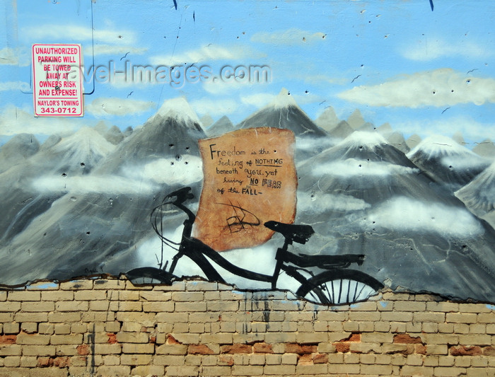 usa1724: Boise, Idaho, USA: bike and mountains - 'freedom is the feeling of nothing beneath you, yet having no fear of the fall' - graffiti on Freak Alley - photo by M.Torres - (c) Travel-Images.com - Stock Photography agency - Image Bank