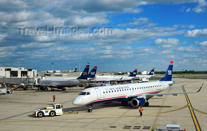 usa2585: Philadelphia, Pennsylvania, USA: Philadelphia International Airport ground operations - an US Airways Embraer ERJ-190 regional jet aircraft is pushed back from the gate by a pushback tractor / tug - photo by M.Torres - (c) Travel-Images.com - Stock Photography agency - Image Bank