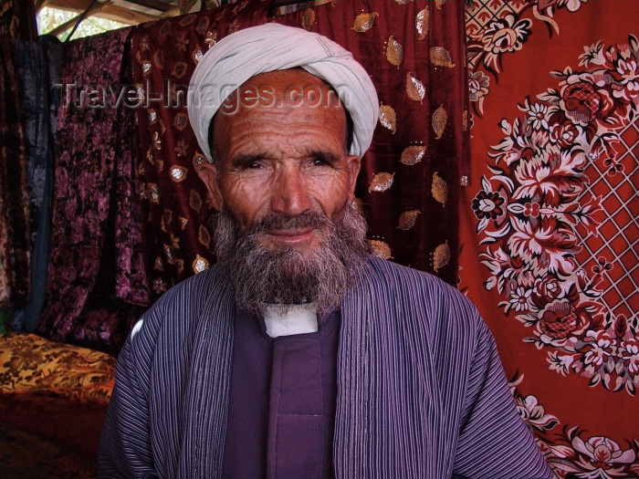 uzbekistan17: Uzbekistan - Samarkand / Samarqand / Samarcanda / SKD : traditional clothes - Uzbetk man at the bazaar - carpets - photo by A.Slobodianik - (c) Travel-Images.com - Stock Photography agency - Image Bank