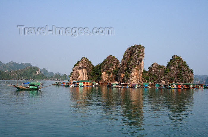 vietnam129: Halong Bay - Vietnam: fishing boat passing a floating village - photo by Tran Thai - (c) Travel-Images.com - Stock Photography agency - Image Bank