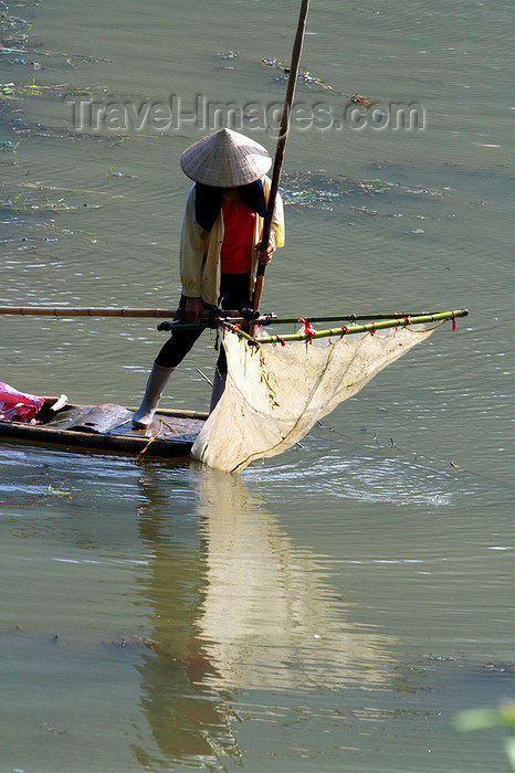 vietnam145: Ba Be National Park - Vietnam: woman is catching fish with a net tied to a bamboo stick - photo by Tran Thai - (c) Travel-Images.com - Stock Photography agency - Image Bank