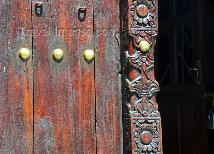 zanzibar53: Stone Town, Zanzibar, Tanzania: decorative carved wooden door with brass knobs - metal studs - International Business Services, below Forodhani Orphanage - Mizingani road - photo by M.Torres - (c) Travel-Images.com - Stock Photography agency - Image Bank