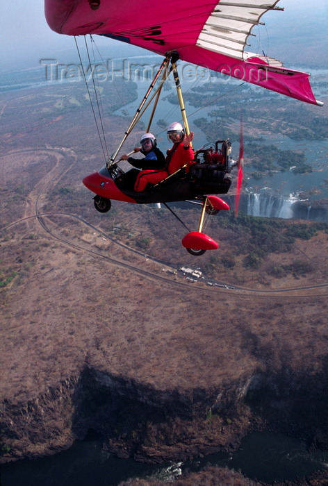 zimbabwe31: Victoria Falls - Mosi-oa-tunya, Matabeleland North province, Zimbabwe: aerial view of Victoria Falls and a Pegasus ultralight trike in flight - Zambezi River gorge on the basalt plateau - photo by C.Lovell - (c) Travel-Images.com - Stock Photography agency - Image Bank