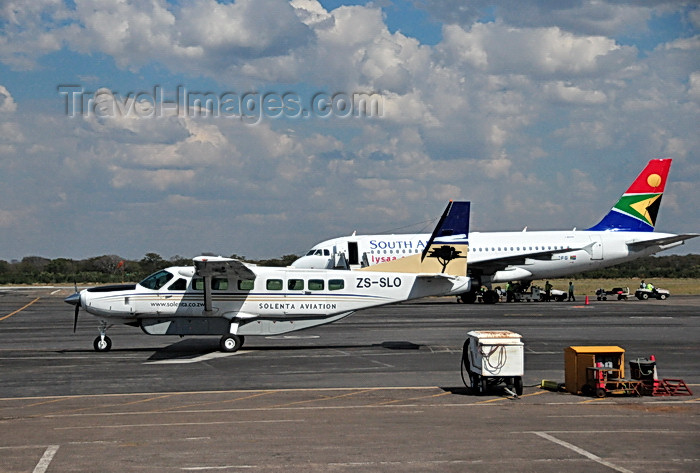 zimbabwe71: Victoria Falls, Matabeleland North, Zimbabwe: Victoria Falls Airport - Solenta Aviation Cessna 208B Grand Caravan ZS-SLO cn 208B0485 and South African Airways Airbus A319,  ZS-SFG cn 2326 - photo by M.Torres - (c) Travel-Images.com - Stock Photography agency - Image Bank