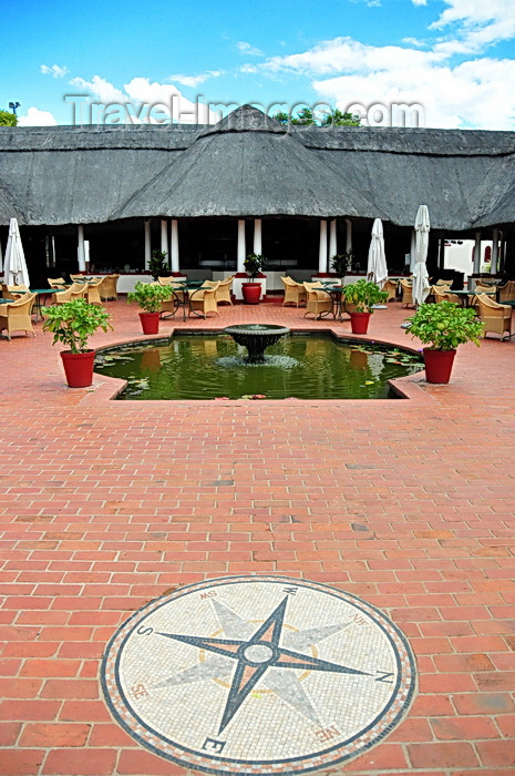 zimbabwe81: Victoria Falls, Matabeleland North, Zimbabwe: Victoria Falls Hotel - Jungle Junctions restaurant, named after the stopover on the Solent Flying Boat service, offered by Imperial Airways - pond and compass rose - photo by M.Torres - (c) Travel-Images.com - Stock Photography agency - Image Bank