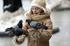 Poland - Krakow: girl feeding pigeons in Rynek (photo by M.Gunselman)