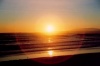 Portugal - Costa da Caparica (Concelho de Almada):  pr do sol no Atlantico - farol do Bugio em fundo - photo by M.Durruti