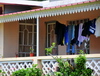 La Ferme, Rodrigues island, Mauritius: creole house with ornate eaves and clothes line - photo by M.Torres