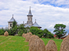Gura Humorului, Suceava county, southern Bukovina, Romania: church, filed and haystacks - rural life - photo by J.Kaman