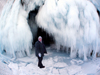 Lake Baikal, Irkutsk oblast, Siberian Federal District, Russia: woman at the entrance of an ice cave on Olkhon island - photo by B.Cain