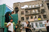 Chechnya, Russia - Grozny - men selling the watermelons from the back of a truck in front of a ruined building - photo by A.Bley