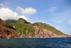 Fort Bay, Saba: harbour and hills seen from the sea - jagged volcanic landscape - photo by M.Torres
