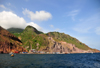 Fort Bay, Saba: harbour and hills seen from the sea - jagged volcanic landscape - photo by M.Torres