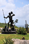 Col de la Tourmente, St. Barts / Saint-Barthlemy: Arawak warrior armed with a lance and sounding a conch shell - pelican and iguana - photo by M.Torres