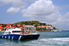Gustavia, St. Barts / Saint-Barthlemy: a divers' boat returns to the harbour - museum and local government buildings in the background - tip of Gustavia Peninsula - photo by M.Torres