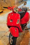 Olbia / Terranoa / Tarranoa, Olbia-Tempio province, Sardinia / Sardegna / Sardigna: red Vespa, an Italian icon - scooter by Piaggio - Corso Umberto I - photo by M.Torres