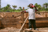 Sierra Leone: village boy taking Coke break - construction site - photo by J.Britt-Green