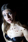 young woman with music score and lyrics projected on her body. Model released - photo by D.Smith