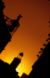 Spain - Madrid: sunset in Puerta del sol - silhouette of Tio Pepe and Casa de Correos - photo by K.Strobel