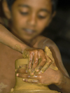near Nuwara Eliya, Central Province, Sri Lanka: young boy working on a potter's wheel - photo by B.Cain