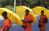 near Dambulla, Sri Lanka: three young monks with umbrellas - photo by B.Cain