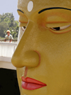 Matara, Southern province, Sri Lanka: temple - Buddha face close-up with tourist - photo by B.Cain