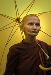 Kandy district, Central Province, Sri Lanka: a Bhikkhuni - Buddhist nun under umbrella - photo by B.Cain