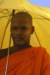 near Dambulla, Sri Lanka: buddhist monk under umbrella - Bhiksu - photo by B.Cain