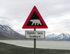 Svalbard - Spitsbergen island: Polar bear danger - road sign reads 'Gjelder hele Svalbard'... i.e.  'Applies to all of Svalbard' - photo by R.Eime