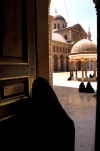 Damascus: Omayyad Mosque - woman's silhouette - leaving the shrine of Zechariah / Hussein - Ancient City of Damascus - Unesco World heritage site - chador-clad woman - photographer: John Wreford