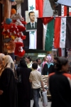 Damascus: Bashar AL Assd poster in the souk - flags of Syria, Iraq and Palestine (photographer: John Wreford)