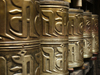 Tibet - Lhasa: Jokhang Temple - prayer wheels - embossed hollow metal cylinders containing a scroll printed with a mantra - photo by M.Samper