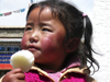 Tibet - Lhasa: girl with sweet - photo by M.Samper