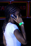Port of Spain, Trinidad: girl with typical hairstyle using a mobile phone - photo by E.Petitalot