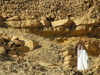 Tunisia - Ksar Douiret: man walking among the rocks (photo by J.Kaman)