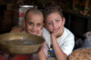Mardin - Southeastern Anatolia, Turkey: buddies - kids in a store - day dreamer deep in his thoughts - photo by J.Wreford