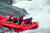 Bujagali Falls, Jinja district, Uganda: white water rafters on an inflatable boat - catarats on the river Nile - seen from the Eastern bank - in 2012 the falls were submerged by the Bujagali Dam - photo by M.Torres