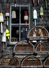 Maine, USA: lobster traps and floats on fishing wharf - wooden house - photo by C.Lovell