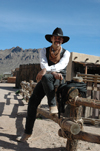 USA - Tombstone, Arizona - O.K. Corral film set - Old Tucson - Crooked Creek chapel - cowboy - sitting on the fence - Photo by K.Osborn