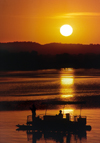 Mississippi, USA: Mississippi river at sunset - raft with pleasure boaters - photo by C.Lovell
