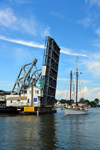 Mystic, CT, USA: Mystic River Bascule Bridgeopens for a sail boat returning to the river - historical drawbridge spanning the Mystic River, built in 1920 -  designed by Thomas Ellis Brown - photo by M.Torres