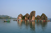 Halong Bay - vietnam: fishing boat passing a floating village - photo by Tran Thai