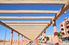 Layoune / El Aaiun, Saguia el-Hamra, Western Sahara: the pergola provides little proctection from the desert sun - Place Oum Saad - photo by M.Torres