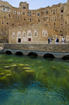 Hababah, Sana'a governorate, Yemen: buildings by the water cistern - arches of the water tank - photo by J.Pemberton