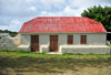 The Valley, Anguilla: old house with cistern - white-washed building with red roof - photo by M.Torres